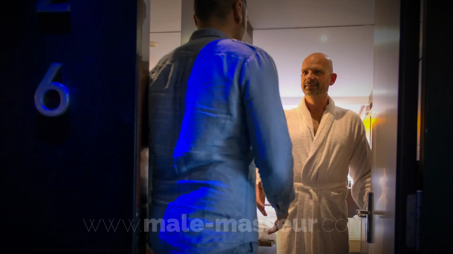 Private male masseur welcoming client in discreet luxury massage studio in Barcelona